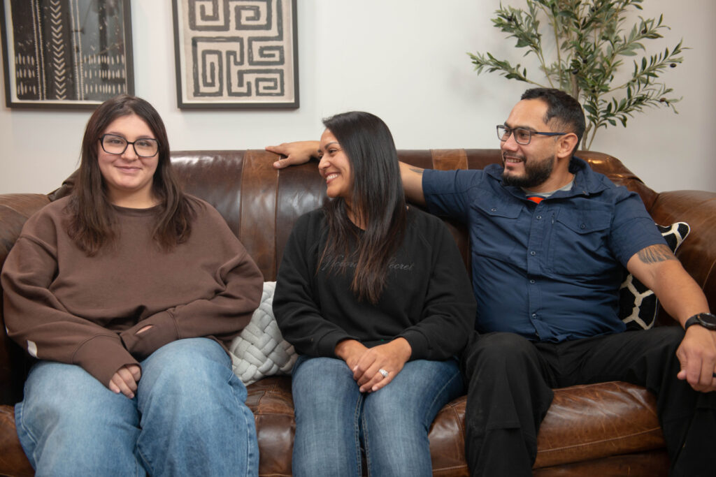 a foster family posing for a photo on a couch