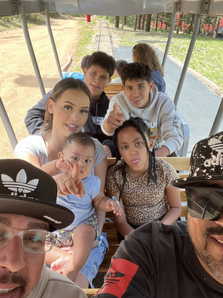 Two dads with their nine year old daughter and 15 year old twin sons and a young adult mother with her baby.